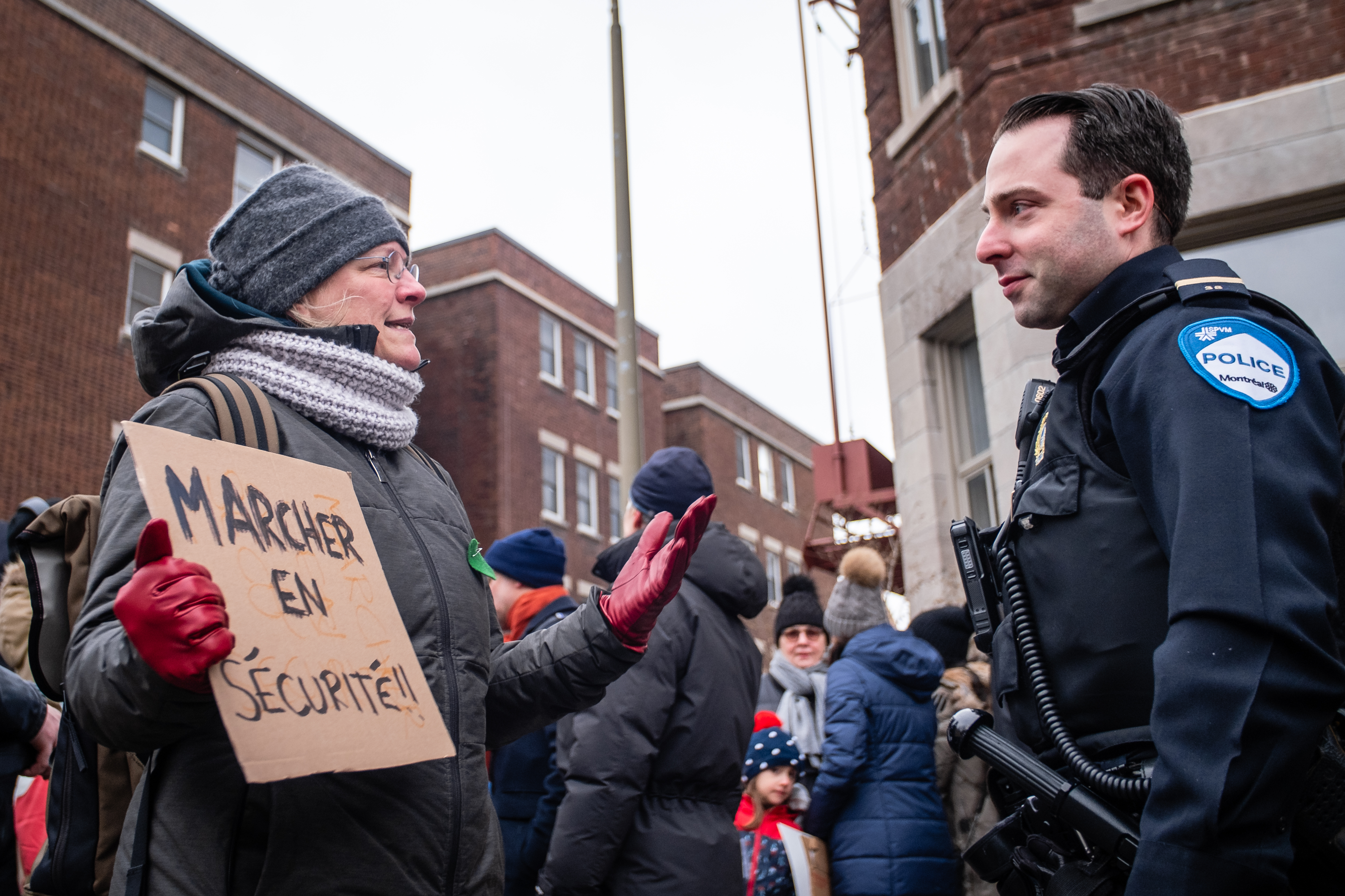 Une citoyenne s'adresse à un agent du SPVM, dimanche, à un rassemblement citoyen pour exiger une révision du Code de la sécurité routière.