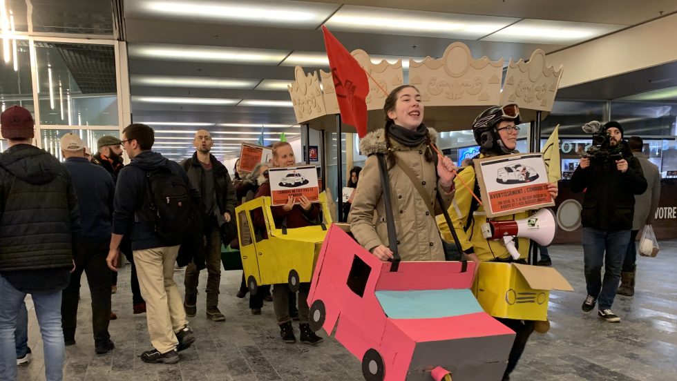 Des représentants et des représentantes d'Extinction rébellion manifestent au Palais des congrès contre l'utilisation de la voiture.