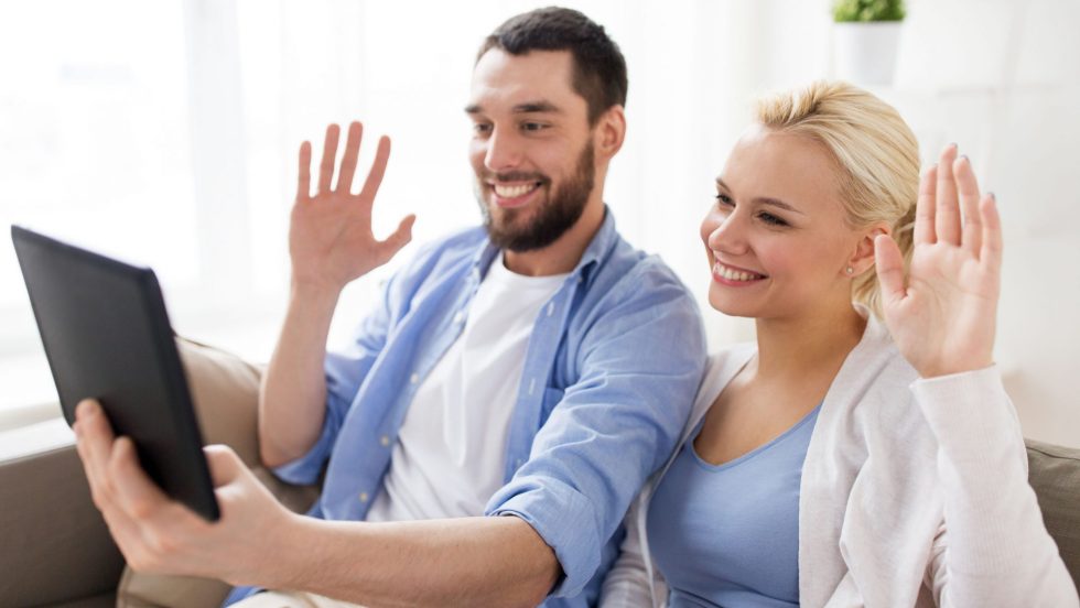 Un couple parle à quelqu'un par le biais d'une tablette