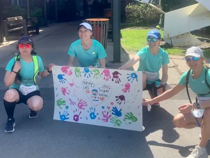 Des infirmières coureuses tiennent une pancarte