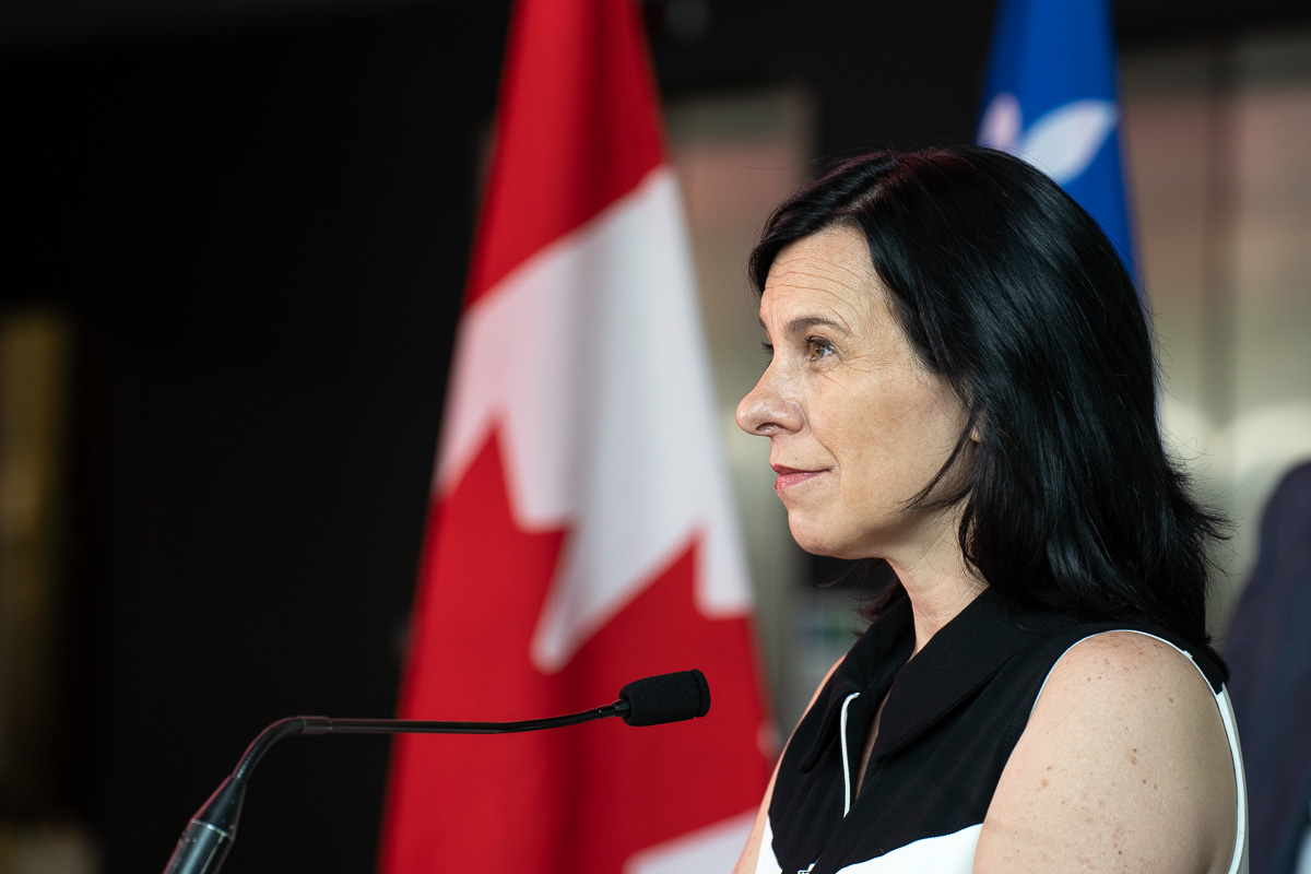 Valérie Plante devant des drapeaux du Québec et du Canada